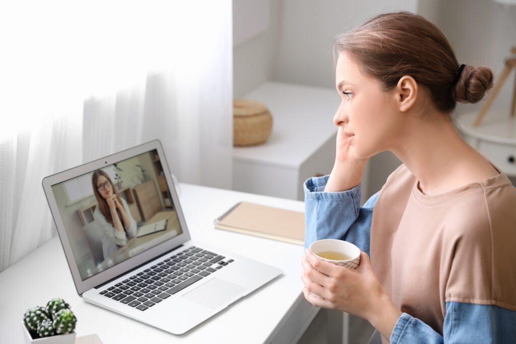 Stressed young woman asking psychologist for advice online at home Telehealth